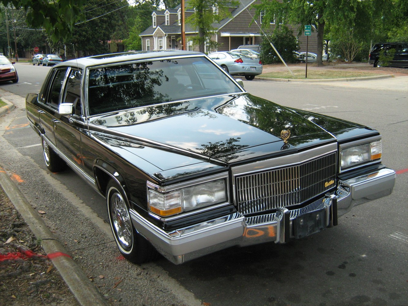 Classic large sedan with chrome grille and wire wheels with whitewall tires.