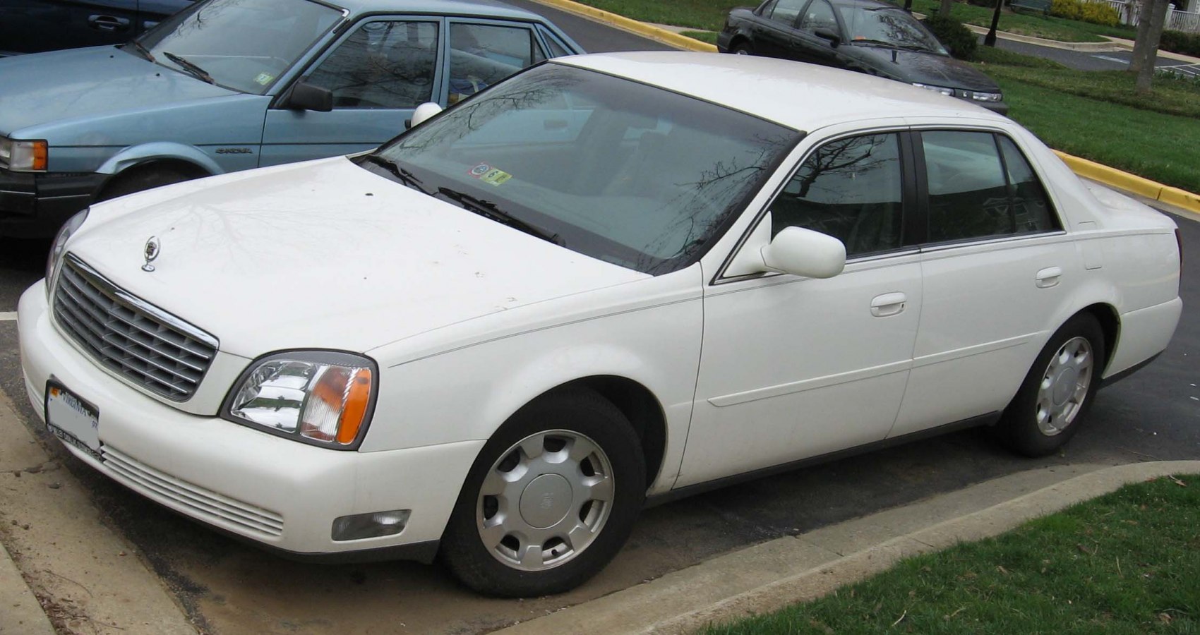 White sedan with classic grille and alloy wheels