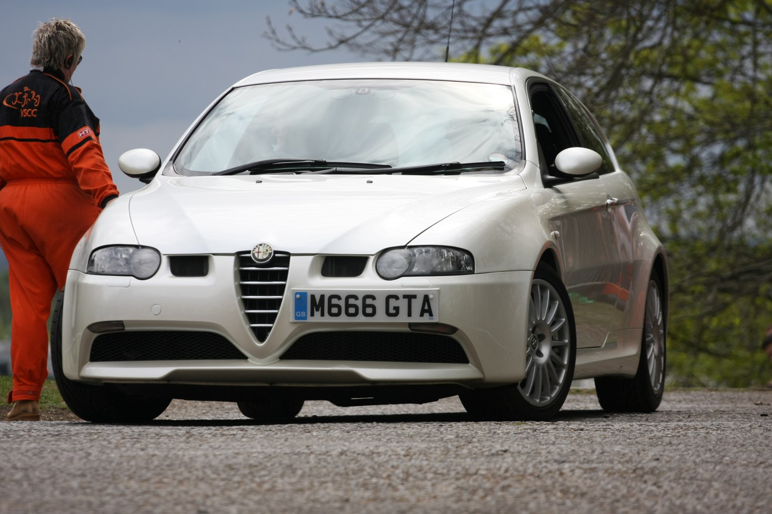White sports hatchback with distinctive front grille and aerodynamic headlights