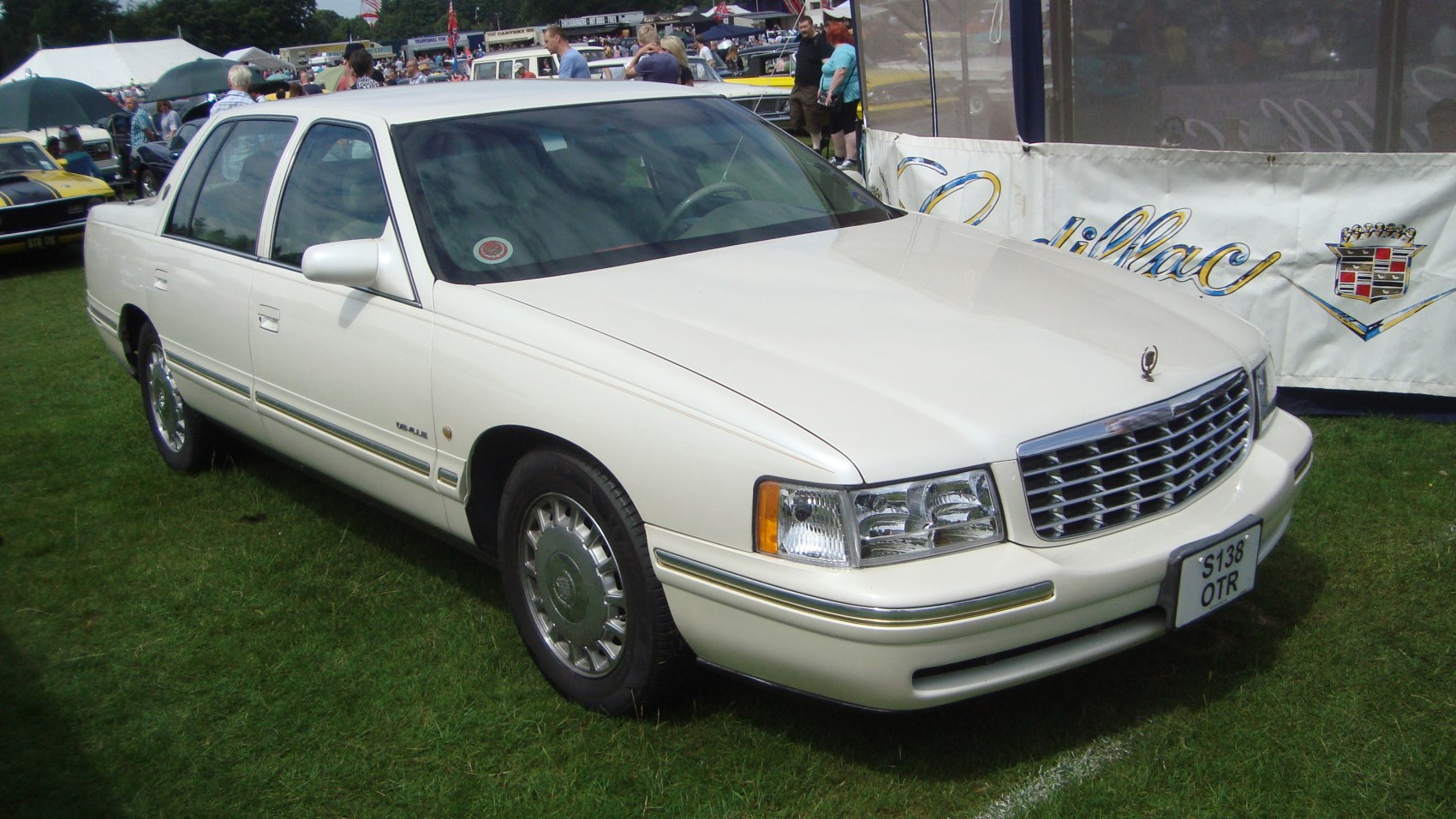 Luxury white sedan with chrome grille and hubcaps