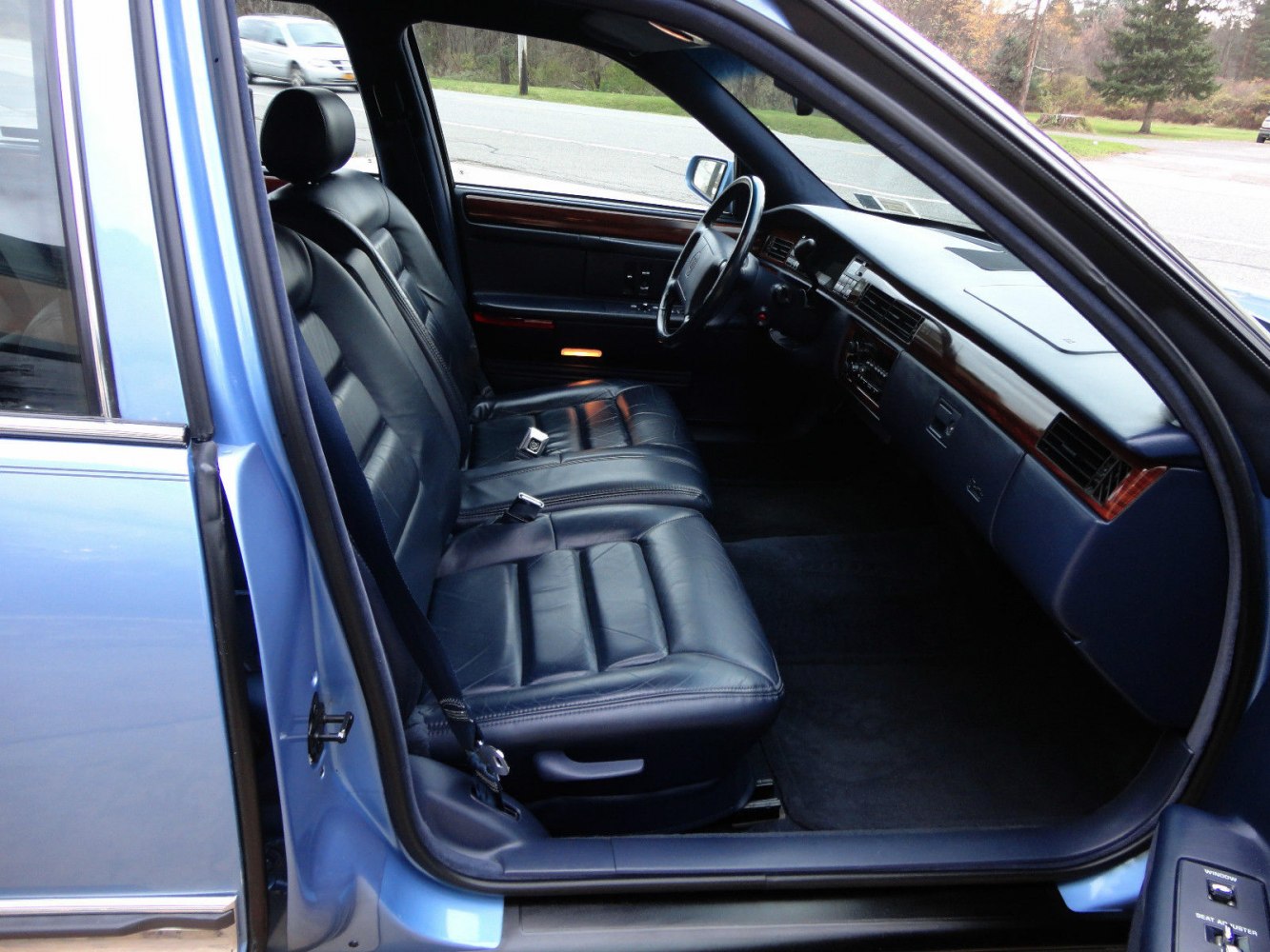 Leather seats and wood trim dashboard in classic luxury sedan interior