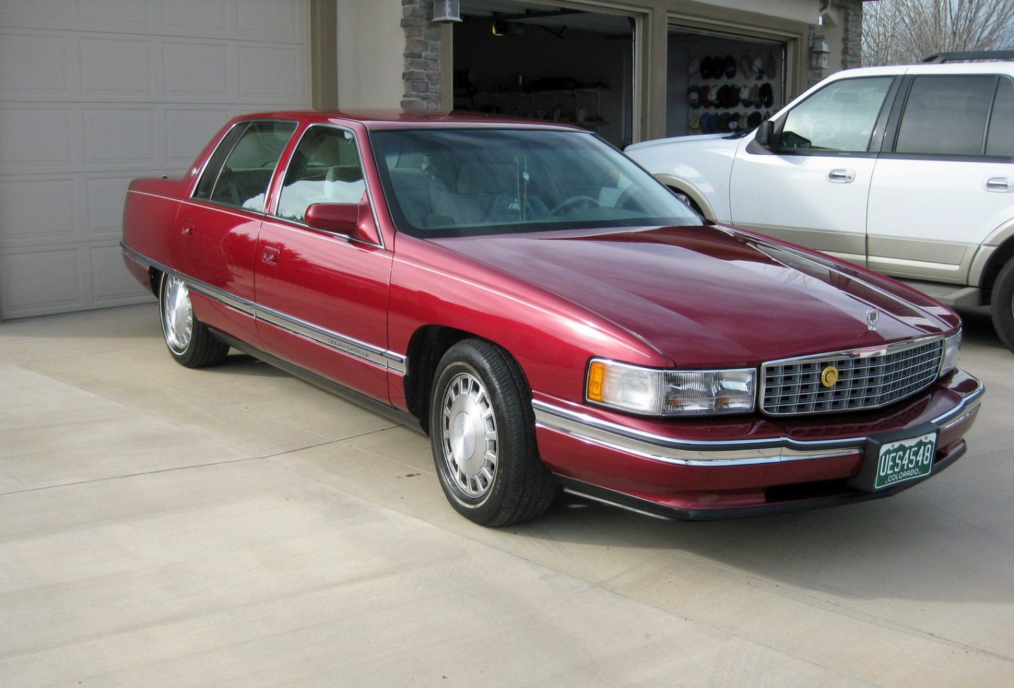 Red luxury sedan with chrome grille and sleek body lines