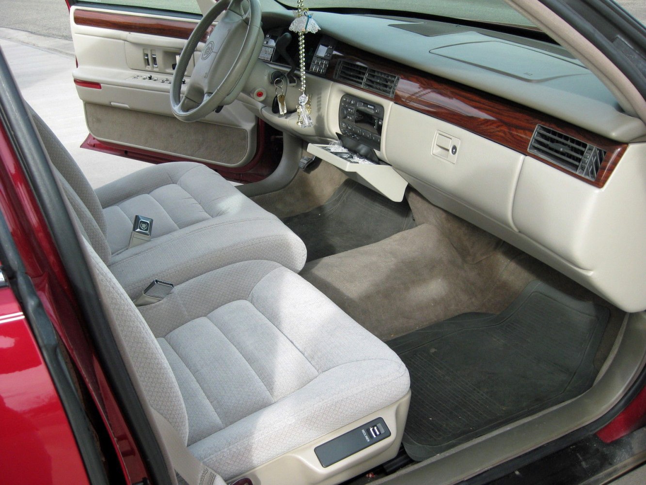 Plush front seats, wood grain dashboard, beige interior
