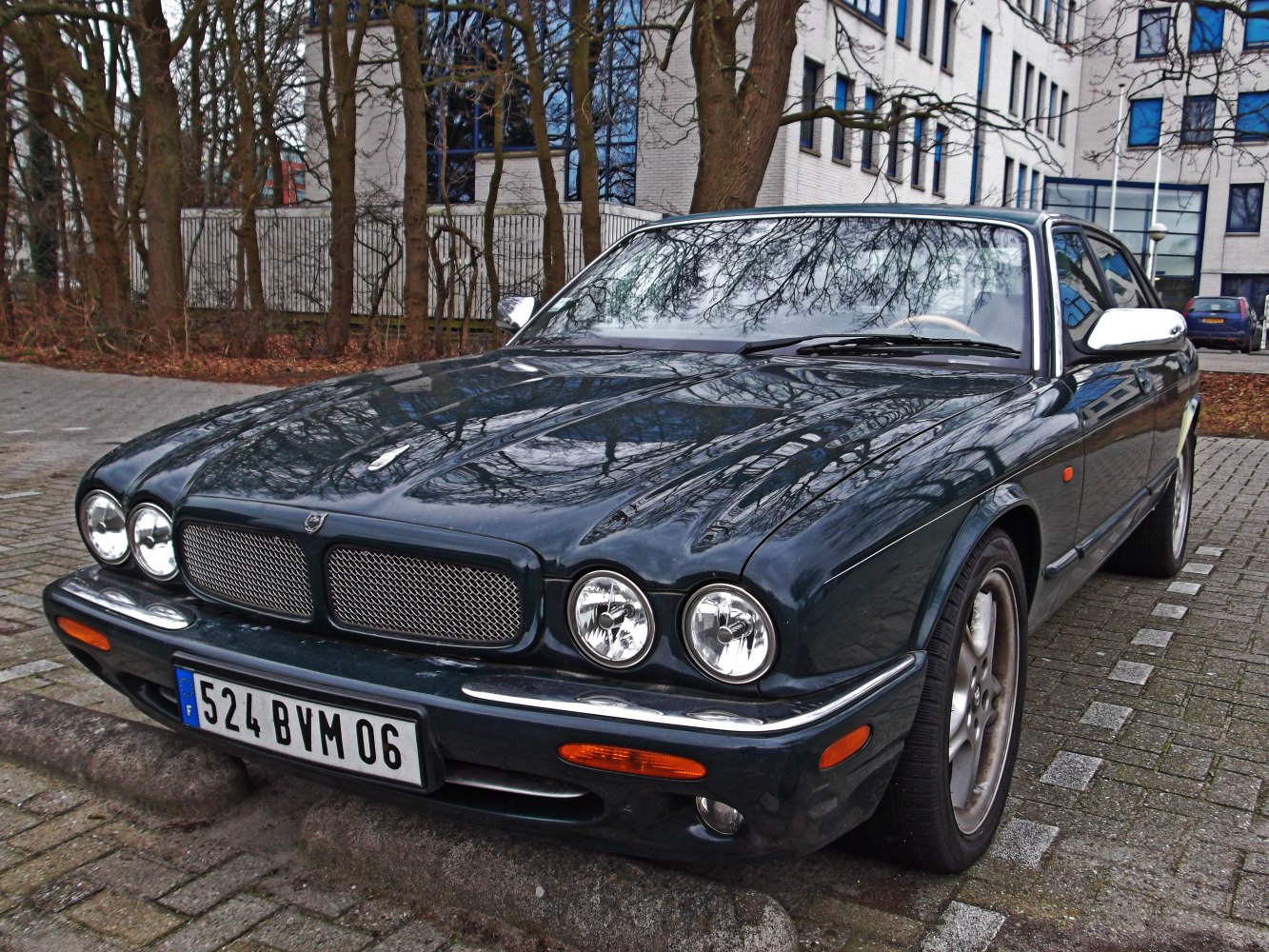 Front view featuring quad round headlights and chrome grille