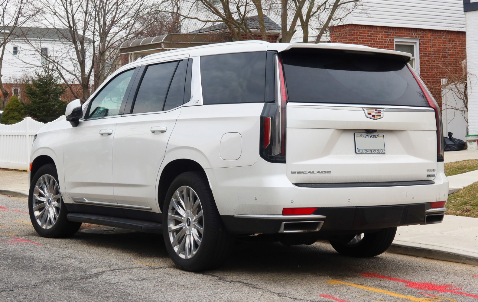 Rear and side view of SUV with chrome wheels and tinted windows