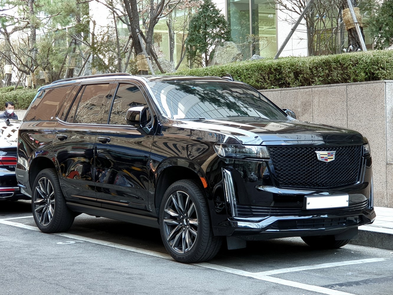 Black SUV with bold grille, LED headlights, and large alloy wheels