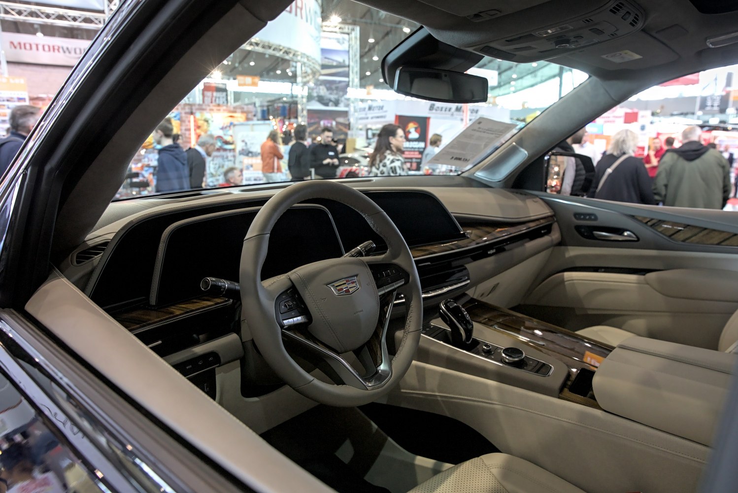 Luxury dashboard and steering wheel with wood trim and leather surfaces