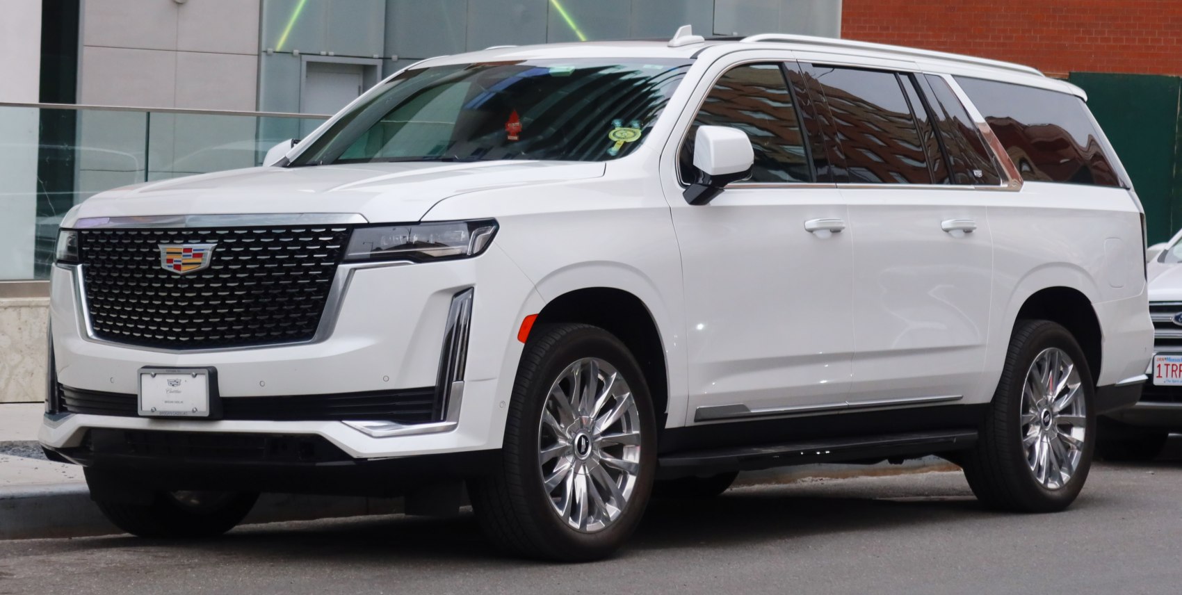 White luxury SUV with bold grille, LED headlights, and alloy wheels