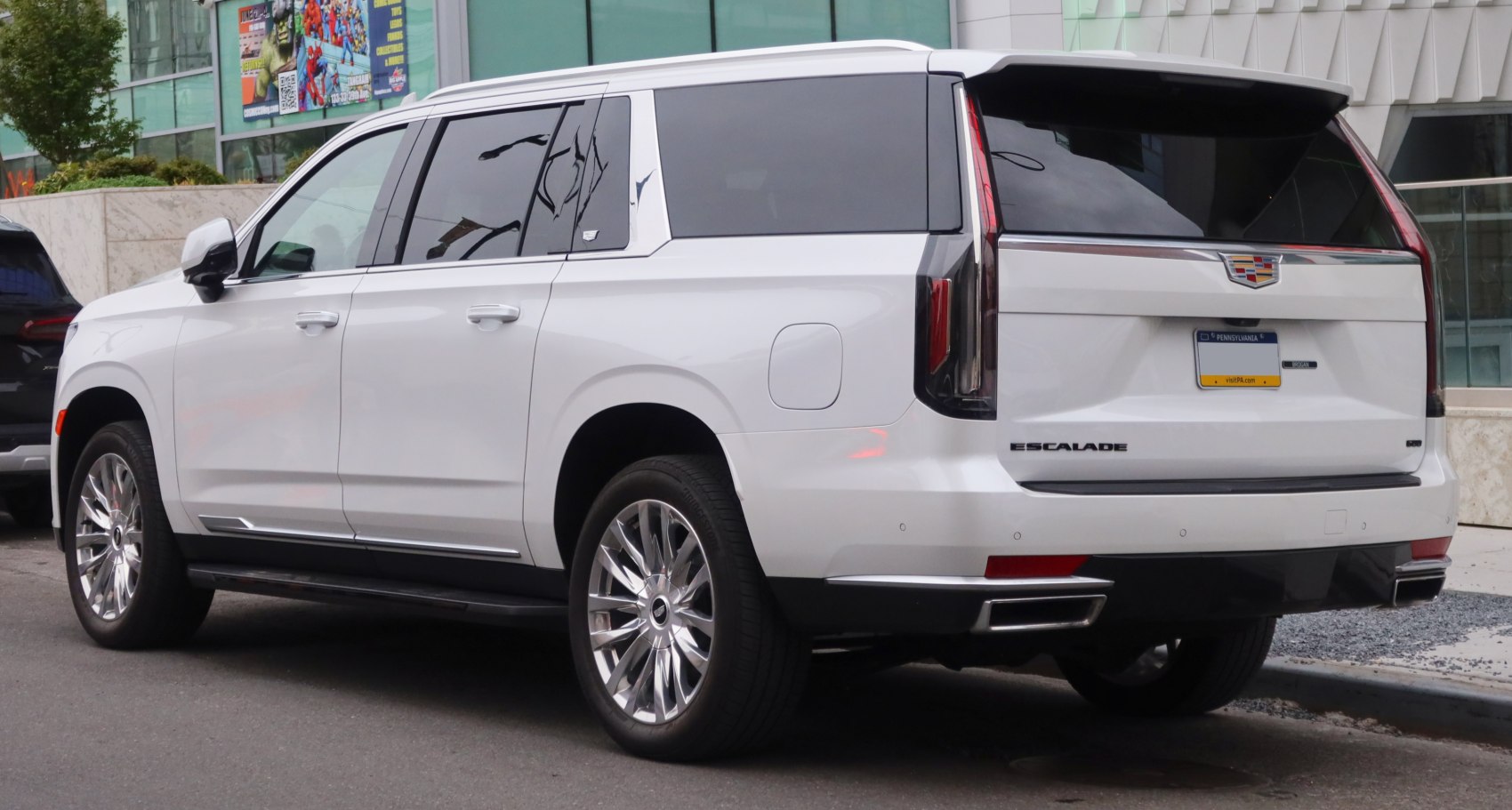 Luxury SUV rear and side view with chrome wheels and tinted windows