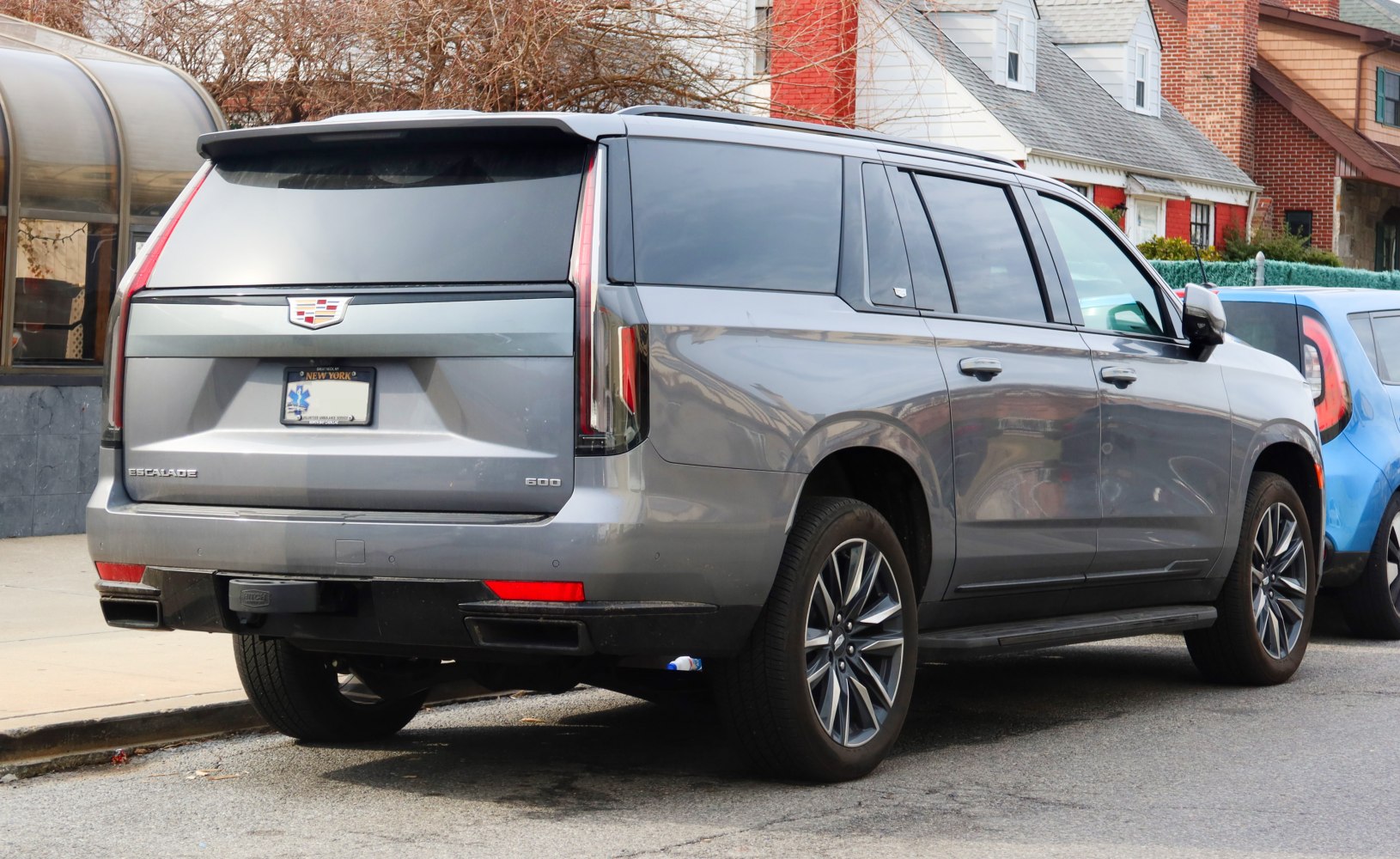 Rear and side view of a modern full-size luxury SUV with tinted windows and alloy wheels.