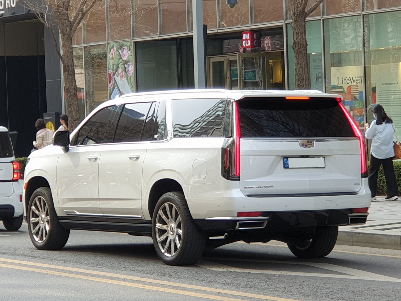 Large luxury SUV rear with vertical LED tail lights and dual exhaust