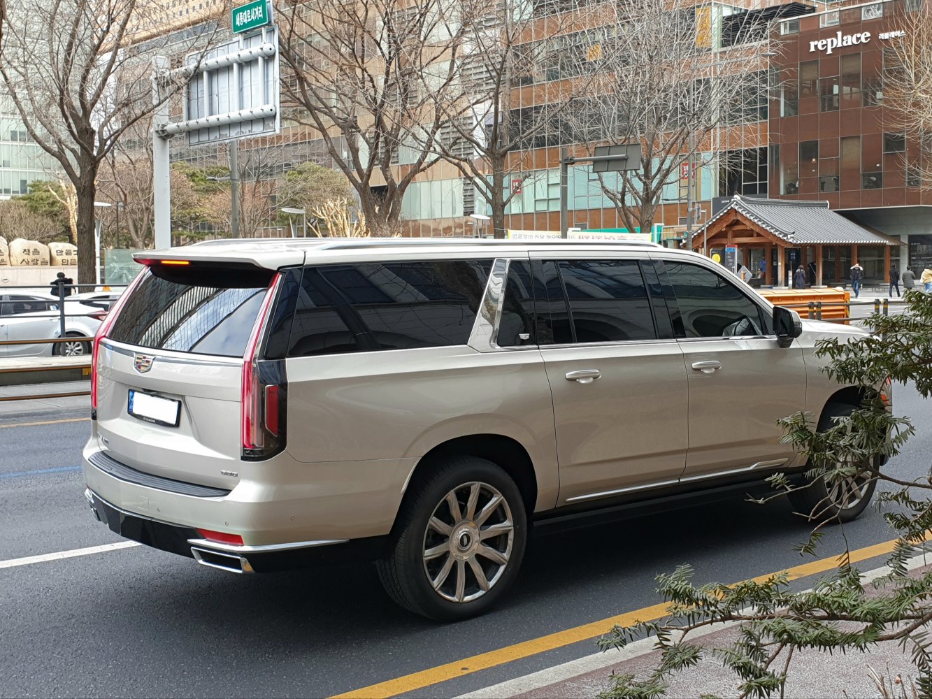 Rear view of a large luxury SUV with vertical tail lights and tinted windows