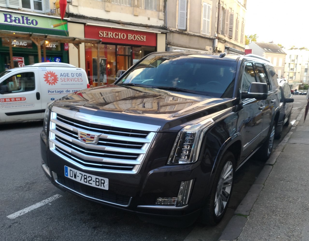 Luxury SUV front with prominent grille and distinctive LED headlights
