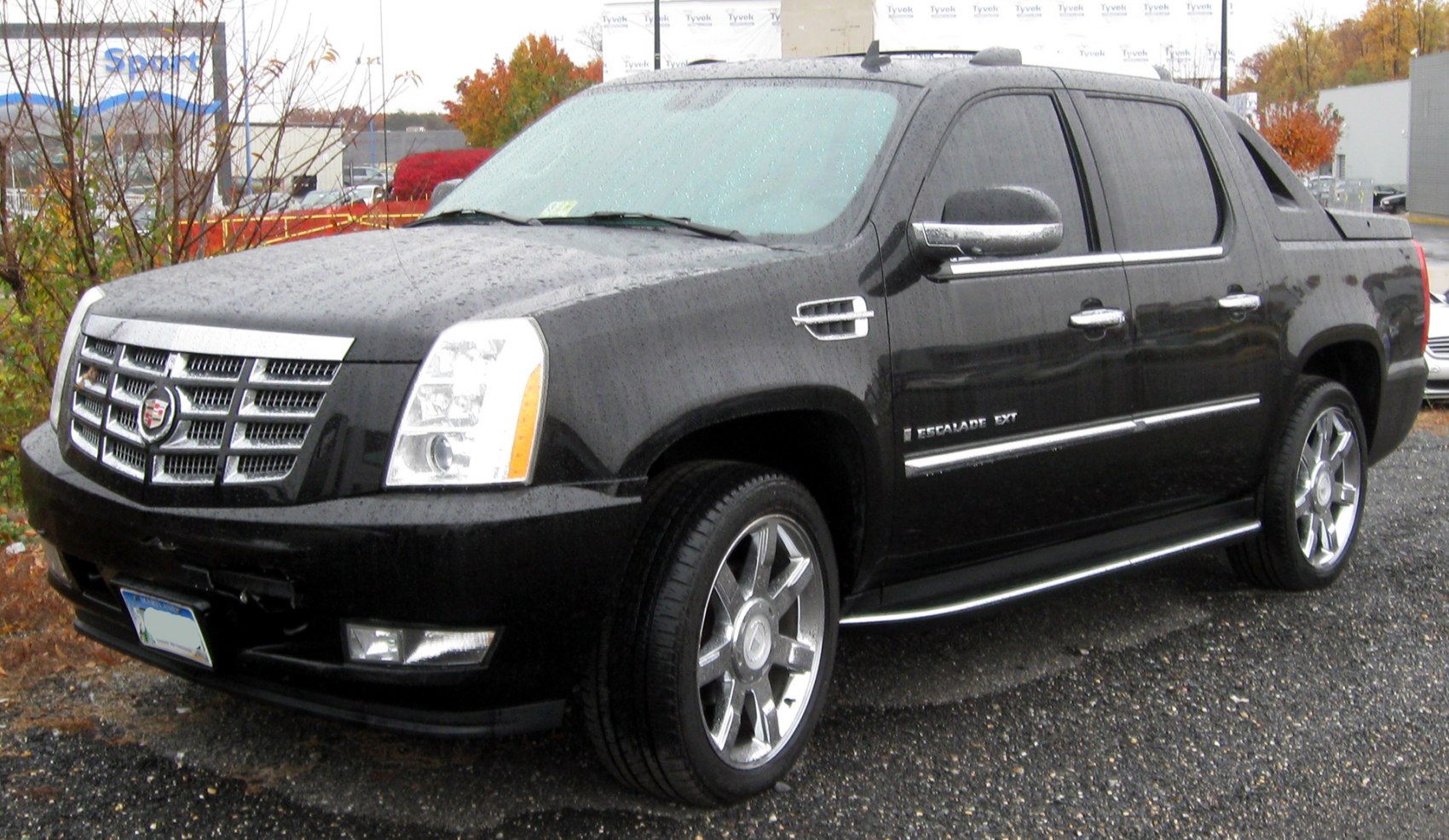 Front and side view of black luxury SUV pickup with chrome grille and rims