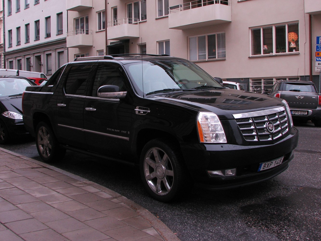 Front-side view of luxury pickup with chrome grille and alloy wheels