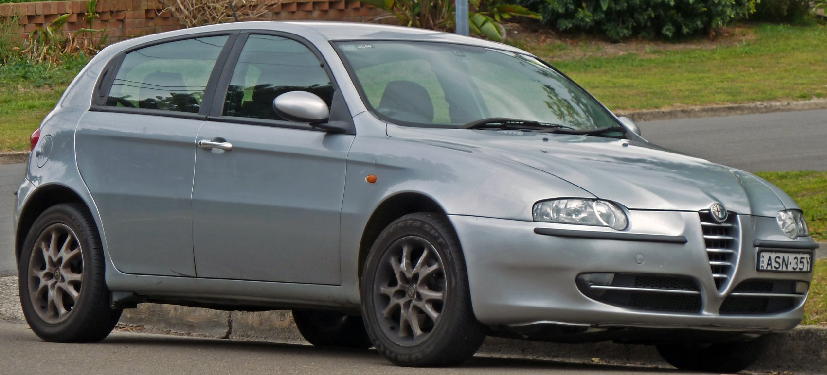 Silver 5-door compact hatchback with distinctive grille and wheels
