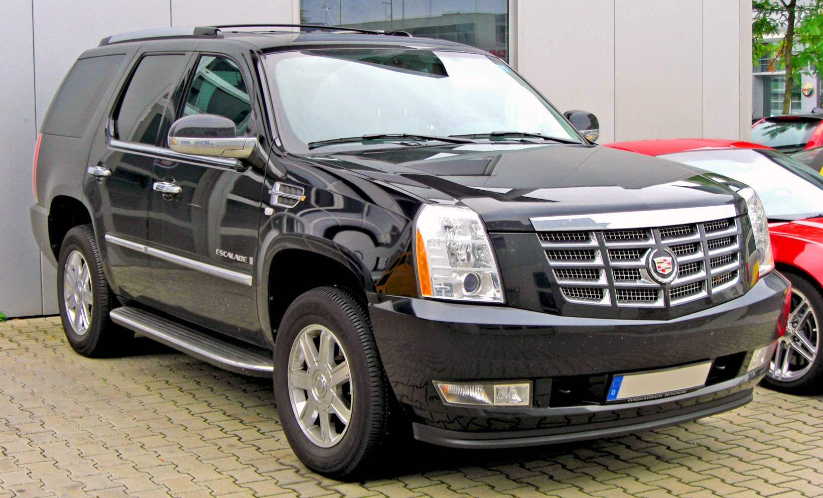 Front side view of black full-size SUV with distinct grille and headlights
