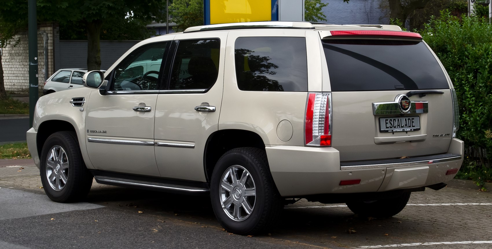Luxury SUV rear-side view with chrome wheels and tinted windows
