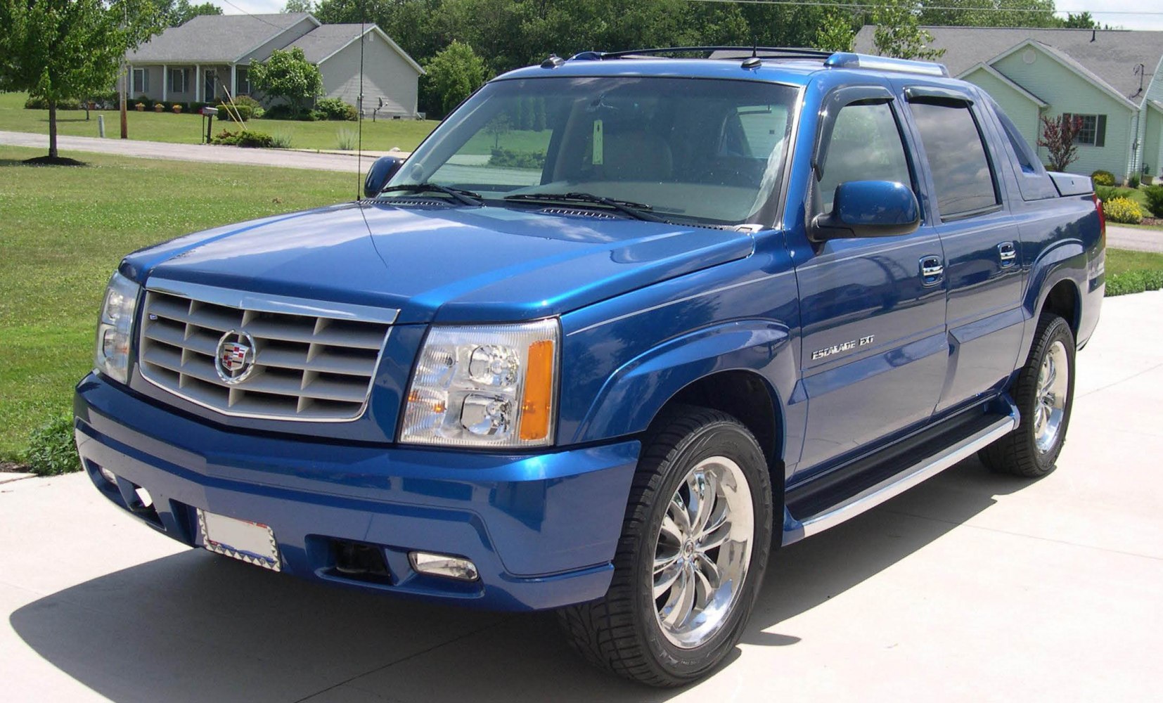 Luxury blue pickup with chrome wheels and distinctive front grille