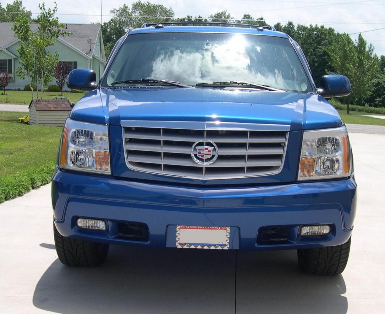 Front grille and dual headlights with fog lamps on a luxury SUV.
