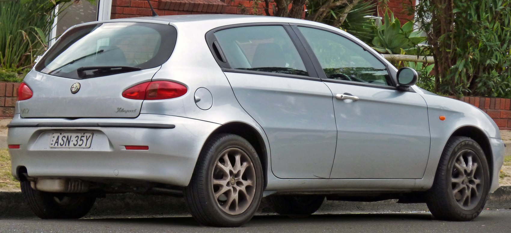 Rear side view of a 5-door hatchback with rounded rear lights and alloy wheels
