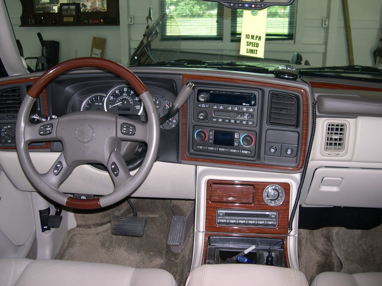 Dashboard and wood-trimmed steering wheel with center console controls
