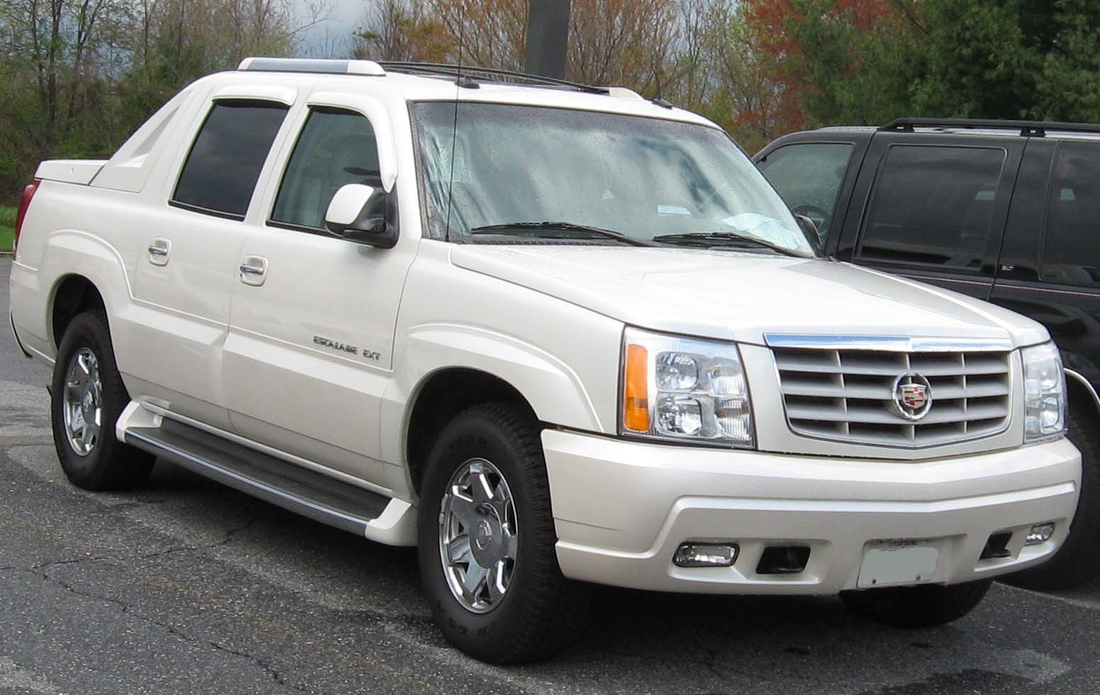 Front-side view of a luxury pickup with chrome grille and alloy wheels
