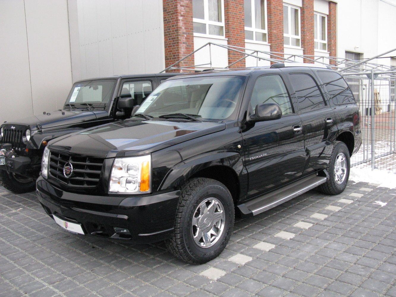 Black luxury SUV with chrome wheels and running boards