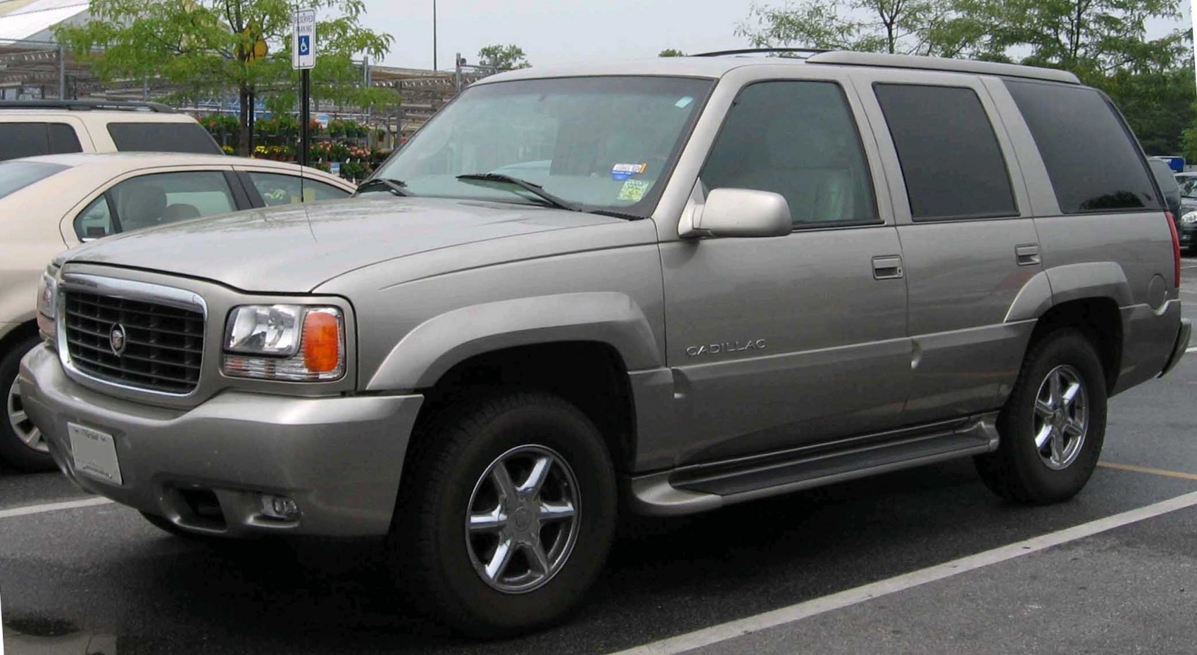 Front side view of a large SUV with distinctive grille and tinted windows.
