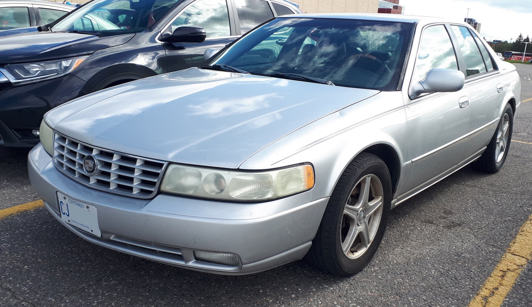 Silver sedan with classic grille and five-spoke alloy wheels