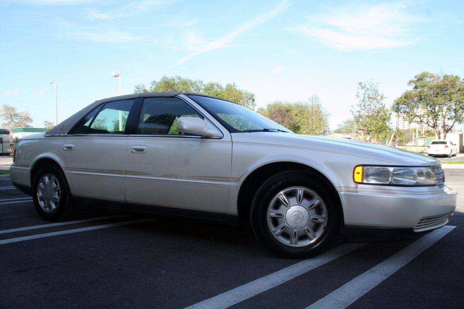 Side profile of a four-door sedan with alloy wheels and vintage styling
