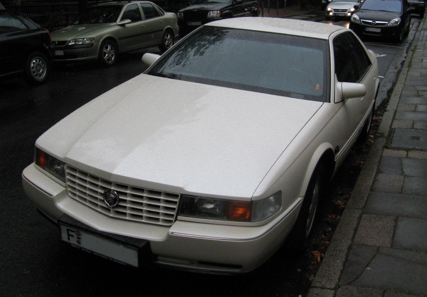 White sedan front with rectangular headlights and horizontal grille
