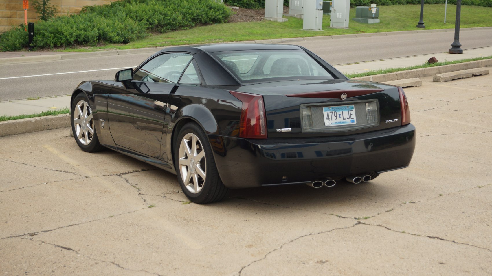 Black coupe with quad exhaust and angular rear design