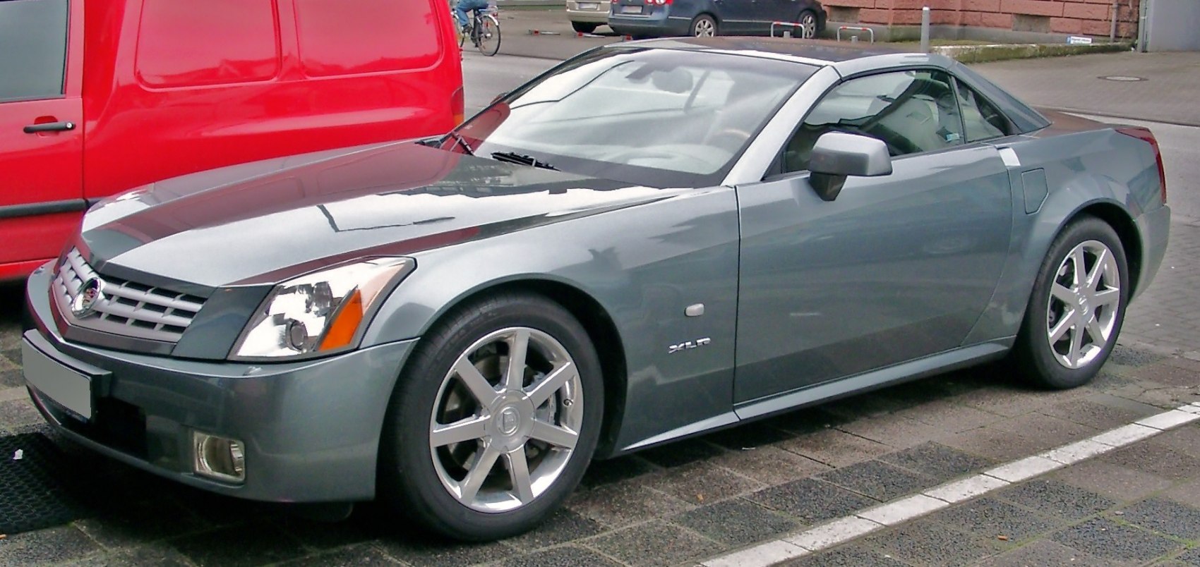 Front side view of silver luxury convertible with sharp design and distinct headlights