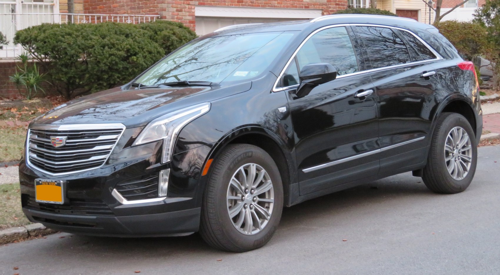 Black luxury SUV with chrome grille, LED lights, and alloy wheels