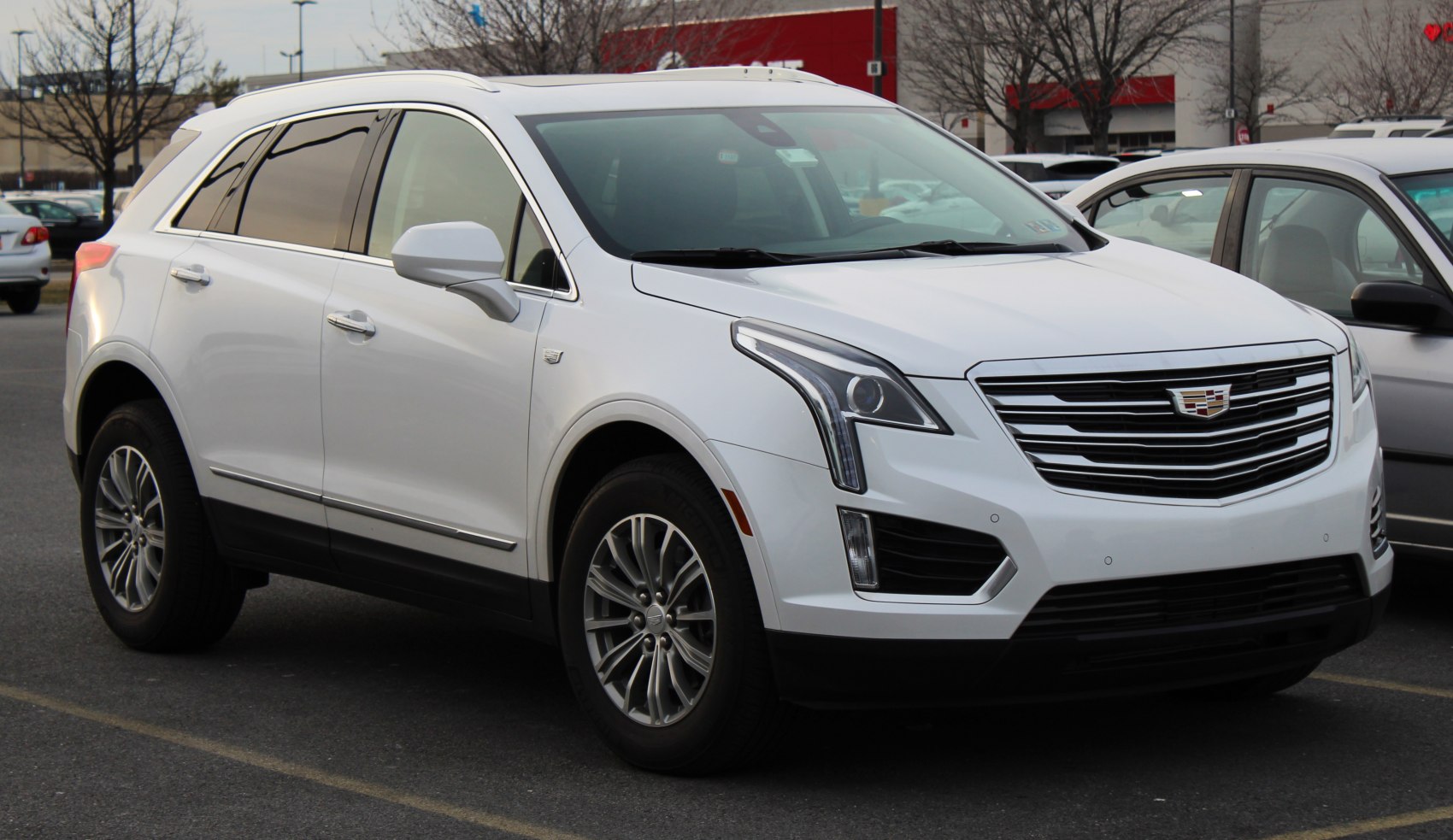 White luxury SUV with chrome grille and vertical LED headlights