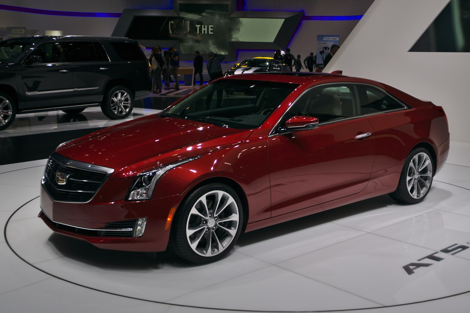 Red luxury coupe with LED headlights and alloy wheels