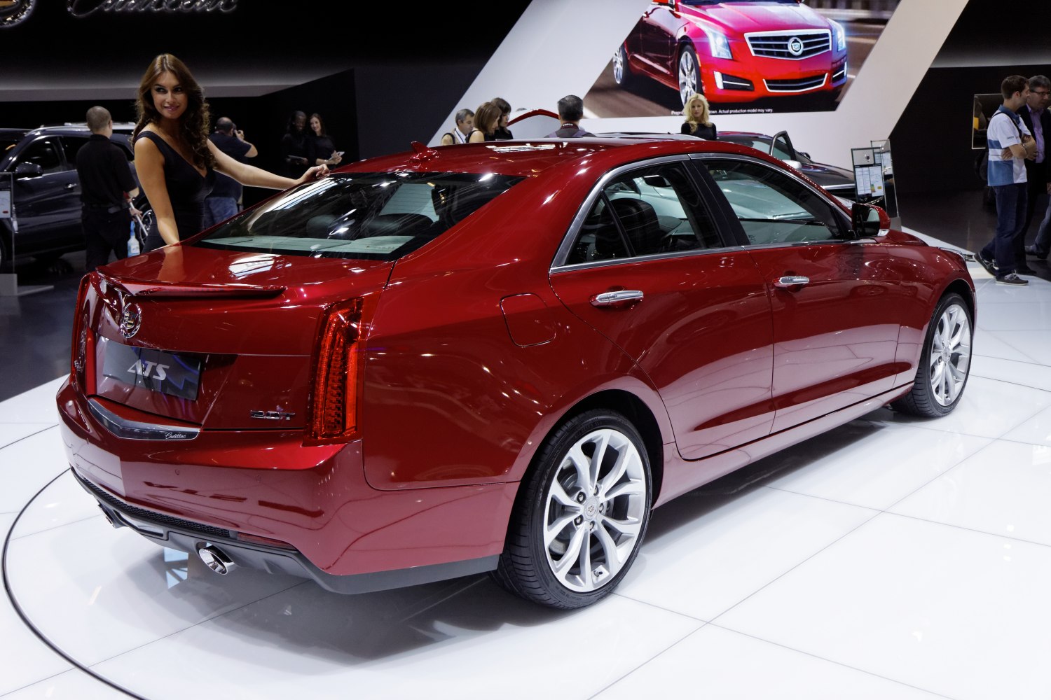 Deep red sedan rear and side view with distinctive taillights and alloy wheels