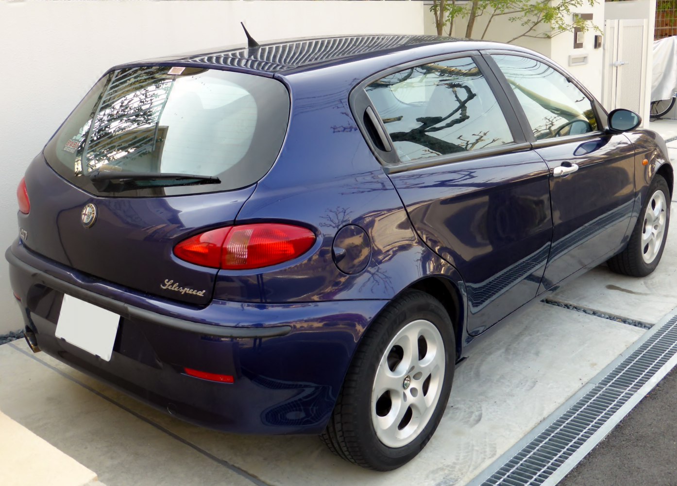 Rear side view with distinctive tail lights and five-door hatchback design