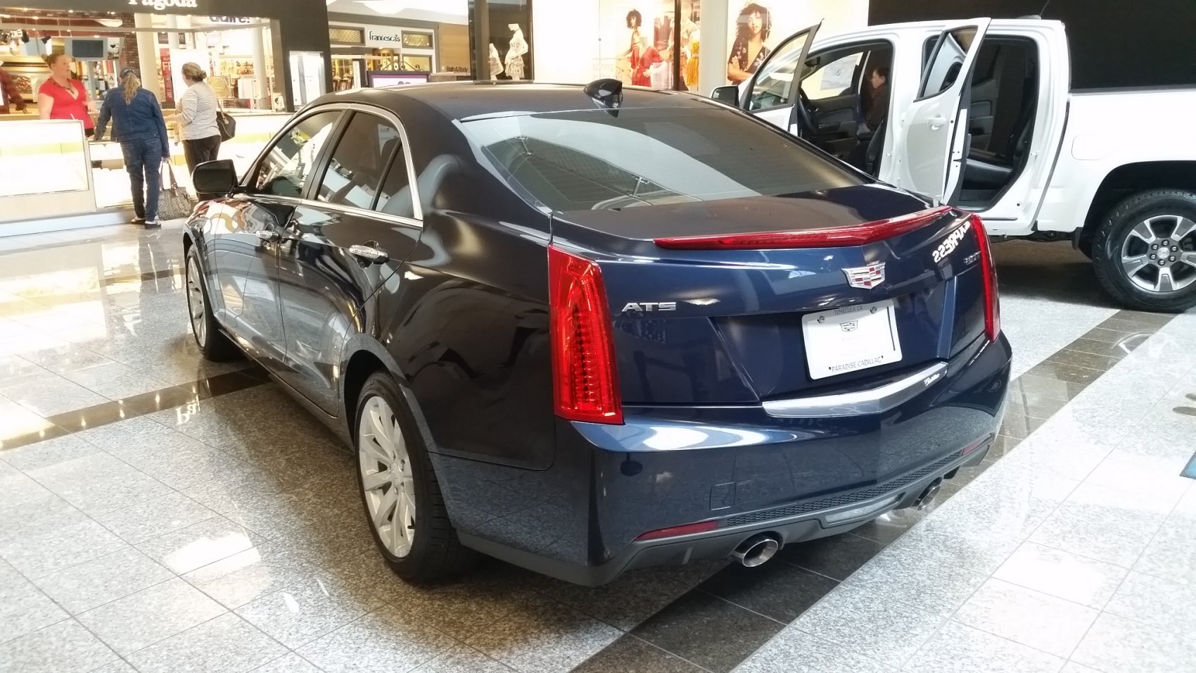 Luxury sedan rear with vertical tail lights and dual exhaust pipes
