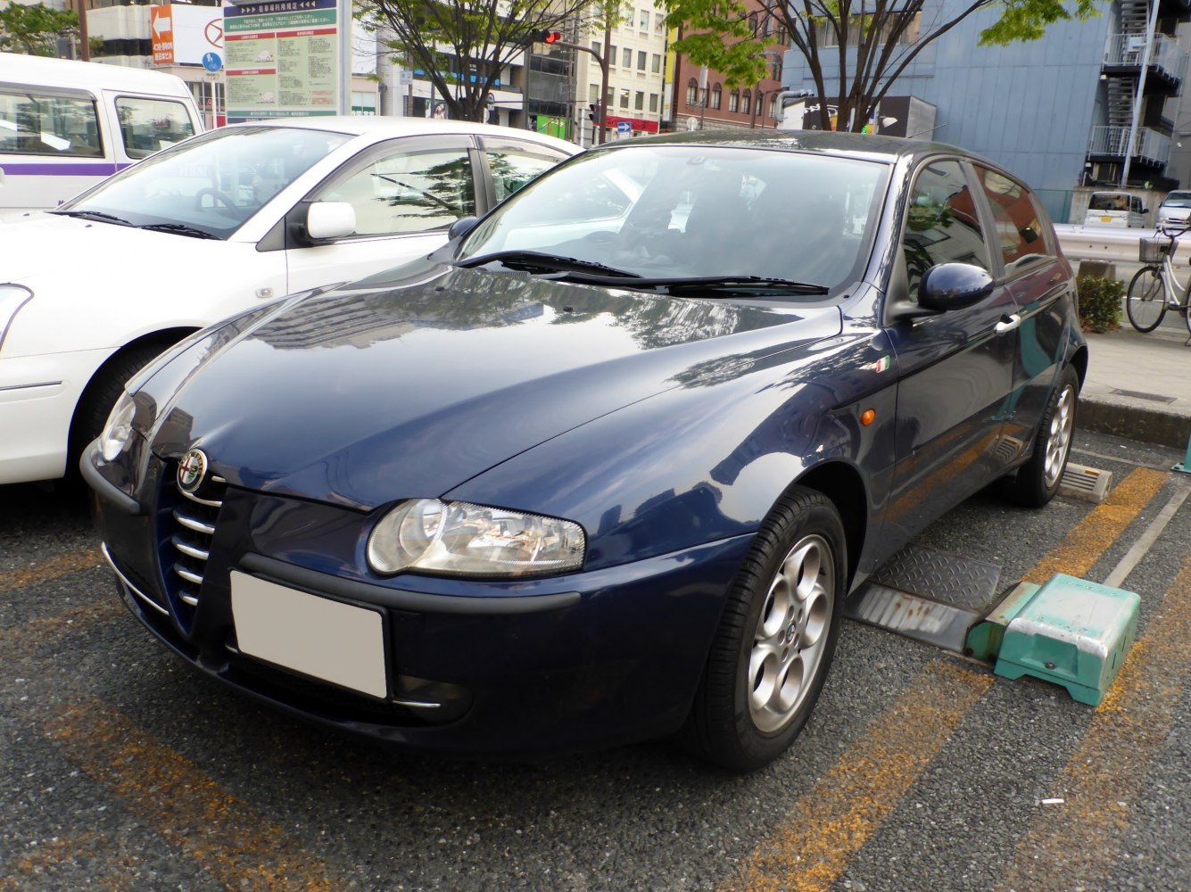 Front-side view of blue 5-door hatchback with rounded headlights and alloy wheels