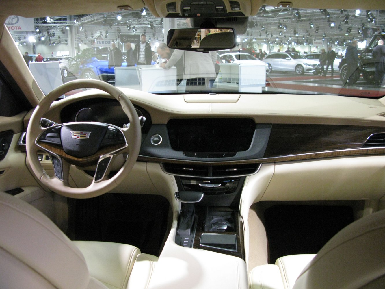 Luxury beige leather car interior with steering wheel and center console