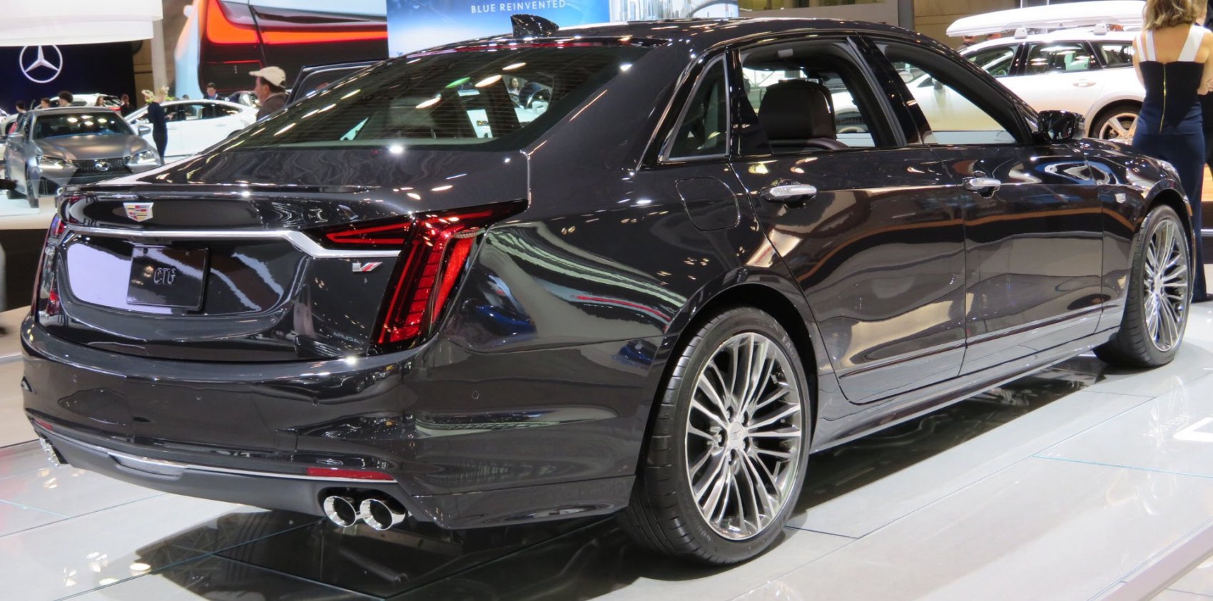 Rear view of luxury sedan with vertical LED taillights and dual exhaust