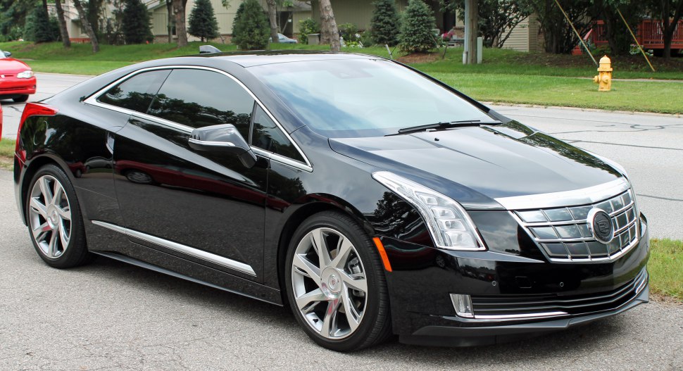 Black luxury electric coupe with chrome grille and tinted windows
