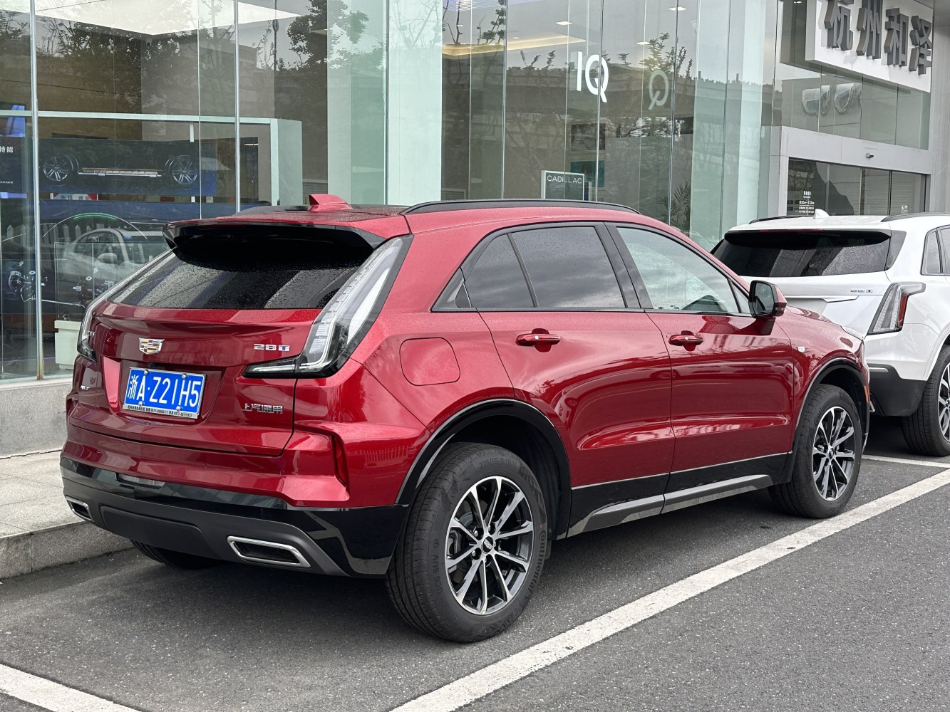 Red compact SUV with vertical LED tail lights and dual exhausts