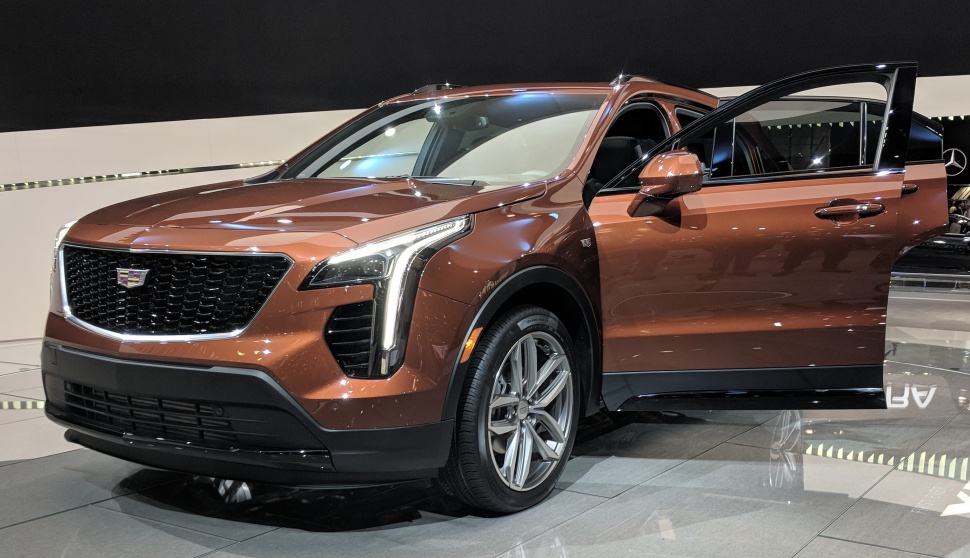 Front view of SUV with vertical LED headlights and open front door