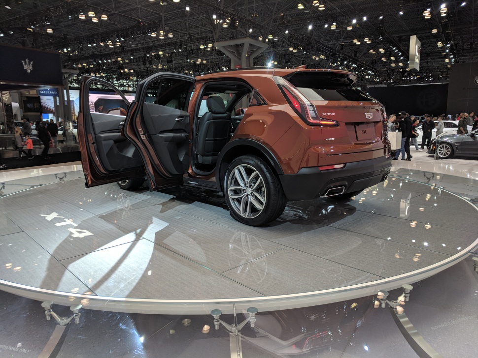 Rear side view with open doors and AWD badge on a modern SUV