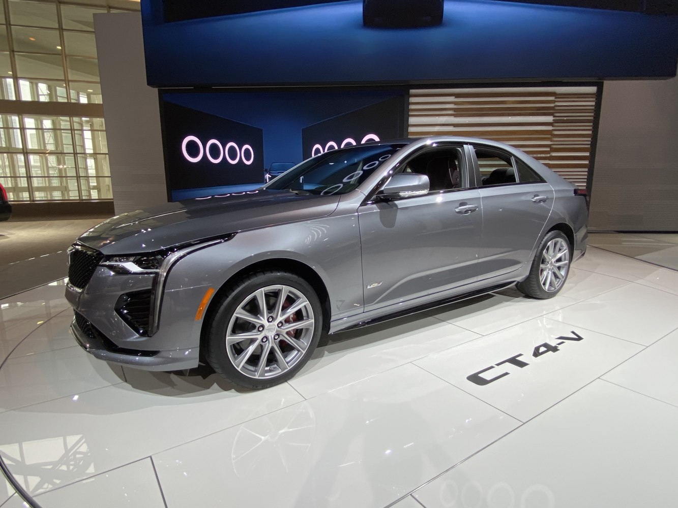 Gray luxury sedan with distinctive LED headlights and alloy wheels