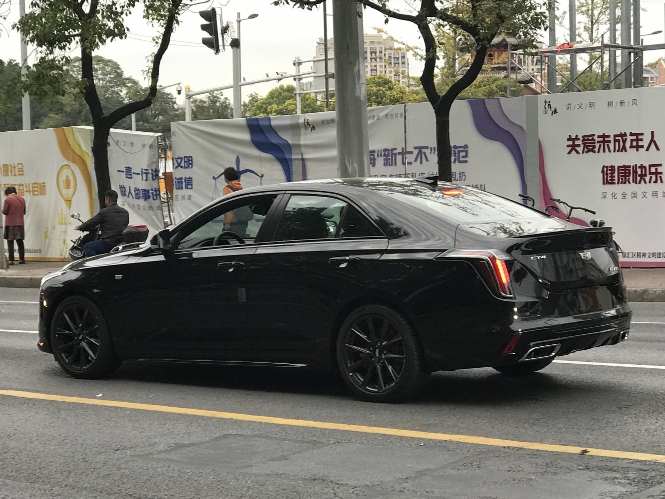 Black luxury sedan with modern LED tail lights and dark alloy wheels