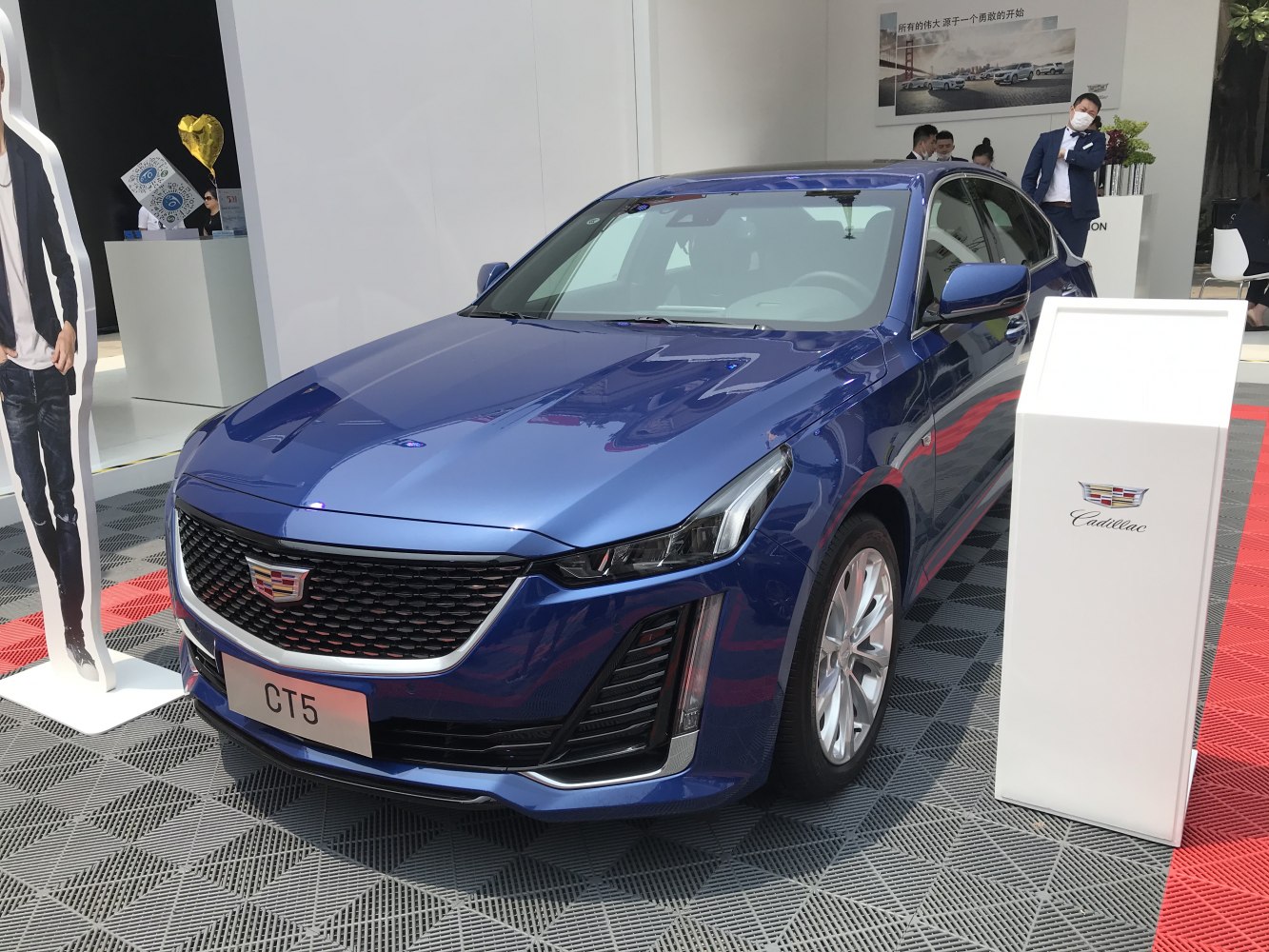 Polished front grille and sleek headlights of a modern sedan.